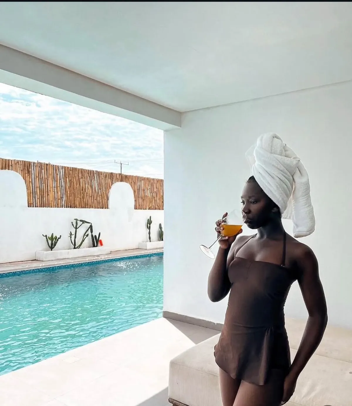 Guest relaxing poolside at a beach house